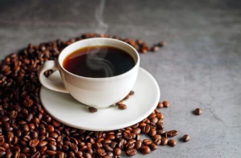 Coffee cup and coffee beans on gray background, Black coffee cup aromatic